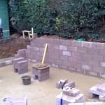 Concrete blocks being laid for pond walls