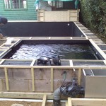 Pond construction finished surround being cladded